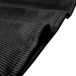 Close-up of black ribbed knit fabric detail showing texture and stitching on men's top