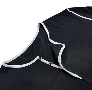 Detail close-up of a men's black Henley shirt collar with contrast trim and buttons