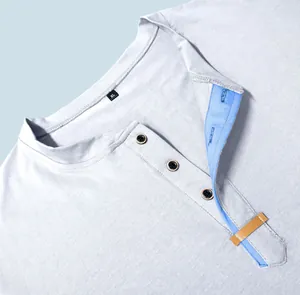 Close-up detail of men's Henley shirt showing blue contrast placket and buttons