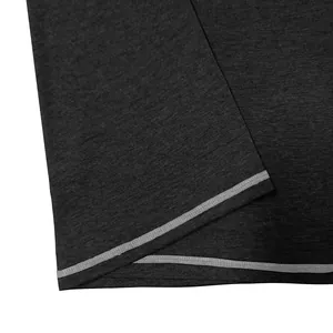 Detailed view of the double-stitched hem on a dark gray moisture-wicking t-shirt