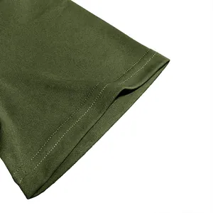 Detail view of olive green polo shirt sleeve cuff showing pique fabric texture and stitching.