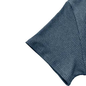 Macro view of navy blue ribbed knit fabric and sleeve cuff on stylish men's casual top