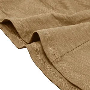Detail shot of high-quality slub cotton fabric and stitching on a khaki men's t-shirt.