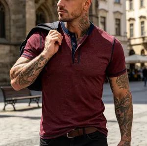 Detail view of maroon short-sleeved Henley shirt with navy trim and button placket
