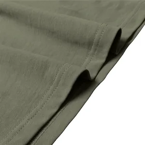 Macro view showing the durable hem stitching and olive green knit fabric of a men's tee