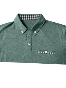Detail of men's polo shirt featuring green fabric and stylish plaid patchwork pocket