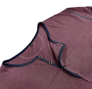 Close-up of maroon long-sleeve Henley shirt collar with wood buttons and navy trim.