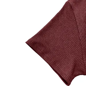Detailed macro view of burgundy ribbed fabric on a men's short sleeve casual t-shirt