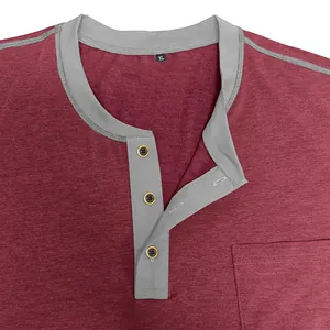 Close-up of maroon men's Henley t-shirt with grey contrast collar, pocket and buttons
