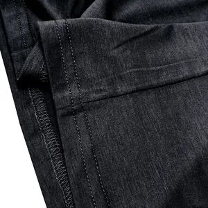 Detailed macro view showing the high-quality stitching on a charcoal grey cotton t-shirt