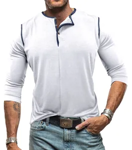 Detailed view of men's white long sleeve Henley shirt with navy blue trim detail