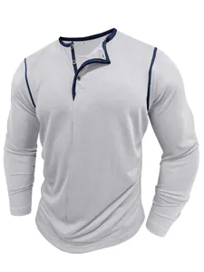 Detailed view of grey long-sleeve Henley shirt with navy contrast trim and buttons