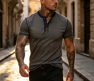 Detailed view of men's grey Henley T-shirt with navy trim in a sunny urban street