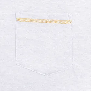 Detailed macro shot of a chest pocket with orange contrast stitching on a men's t-shirt