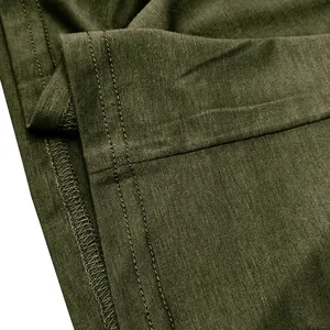 Macro detail of army green cotton T-shirt showing high-quality double-needle stitching.