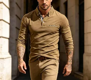 Detailed view of men's casual mustard polo shirt with plaid trim on collar and pocket