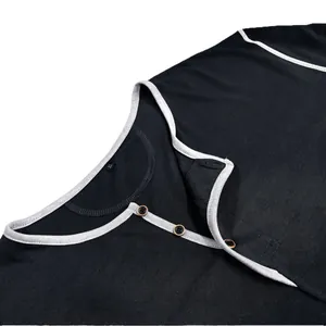Detail view of black men's long sleeve Henley shirt with white contrast trim and buttons