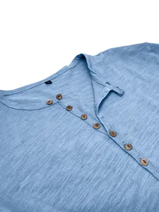 Close-up of men's blue slub cotton Henley shirt showing button collar texture detail.