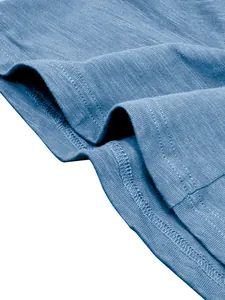 Close-up of blue slub cotton fabric texture and stitching on men's Henley shirt.