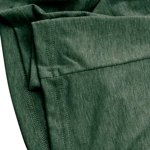 Close-up of green cotton T-shirt fabric showing high-quality stitching and texture