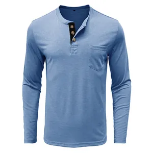 Macro view of men's blue long sleeve cotton Henley shirt featuring breast pocket detail