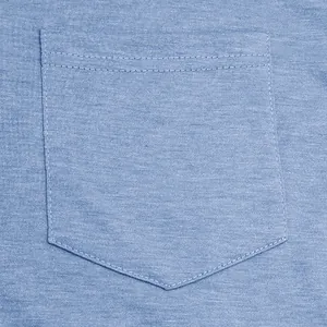 Detail shot of a light blue cotton T-shirt pocket with clean stitching finish