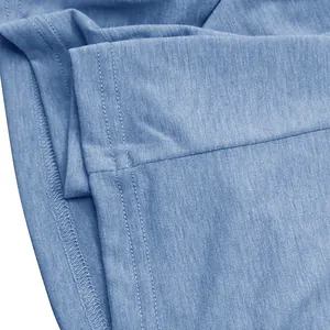 Macro view of blue heathered breathable cotton fabric with fine reinforced stitching