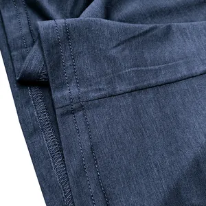 Macro view showing high-quality double-stitched hem and fabric texture of a blue T-shirt