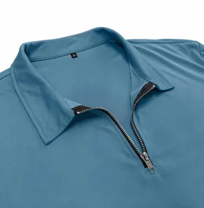 Close-up of blue men's polo collar with zipper detail and textured piqué fabric
