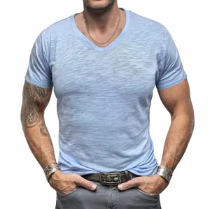 Detailed view of light blue slub cotton texture on men's V-neck T-shirt