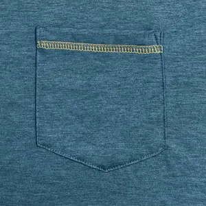 Close-up detail of pocket with yellow contrast stitching on teal quick-dry fabric.