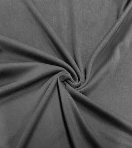 Detailed macro shot of textured dark gray knit fabric for men's polo shirt with drape