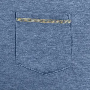 Detail shot of a men's blue heather shirt pocket featuring yellow contrast stitching