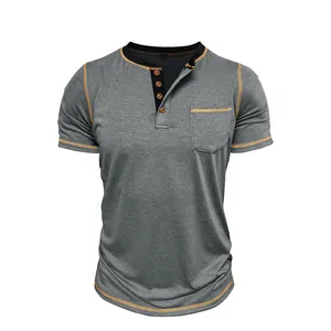Close-up detail of grey short-sleeve Henley shirt with orange contrast stitching and pocket
