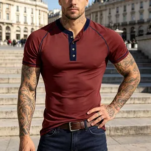 Detail view of a maroon slim fit men's Henley T-shirt with navy raglan sleeve contrast stitching