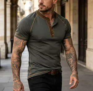 Detailed view of dark green Henley t-shirt with brown contrast collar