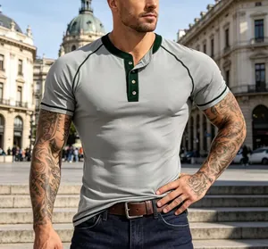 Detailed shot of grey men's Henley shirt with green contrast trim on city street