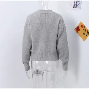 Back view of a grey long-sleeved ribbed knit cardigan shown on a transparent mannequin.