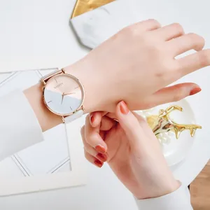 Close-up of a minimalist women's quartz watch with an elegant two-tone dial design