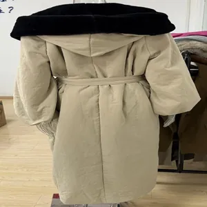 Back view of long beige hooded winter coat with black faux fur collar and waist tie detail
