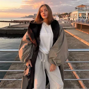 Long trench coat featuring a luxurious dark fur collar and oversized puff sleeves