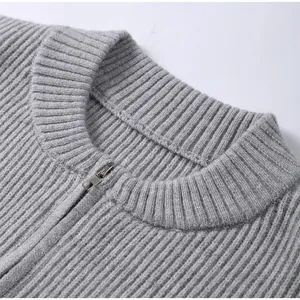 Detailed macro shot of a grey knitted cardigan with elegant silver zipper neckline
