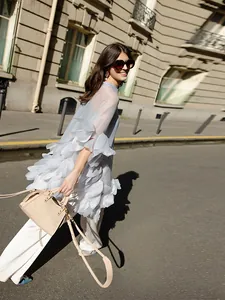 Street style view of elegant sheer light blue blouse with delicate 3D petal floral details