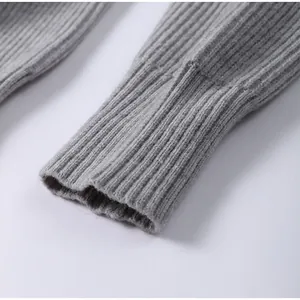Macro detail view of grey ribbed knit sweater cuff showing high quality soft yarn texture