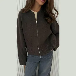 Close-up detail of the dark brown long-sleeve knit cardigan with front zipper closure