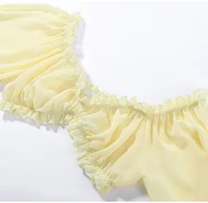 Close-up detail view of yellow ruffled off-the-shoulder neckline on sweet chiffon top