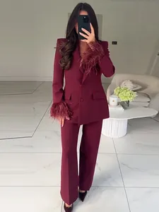 Elegant burgundy two-piece suit set with luxurious feather trim detail on the sleeve cuffs