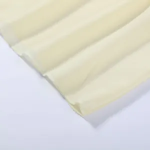 Detail shot of the delicate stitched hem on a light yellow tiered resort maxi skirt