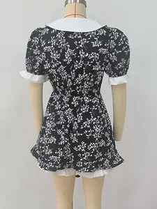 Back view of a black floral print dress with a white Peter Pan collar on mannequin
