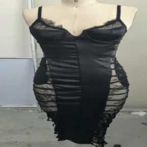 Detail of a black lace patchwork spaghetti strap bodycon dress with side lacing